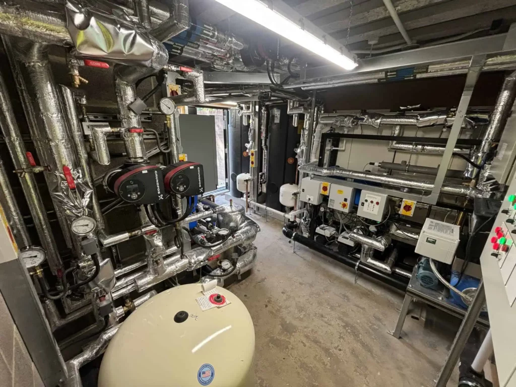Industrial boiler room with pipes and equipment.