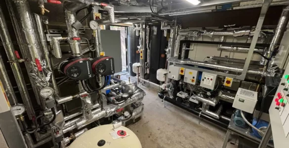 Industrial boiler room with pipes and equipment.